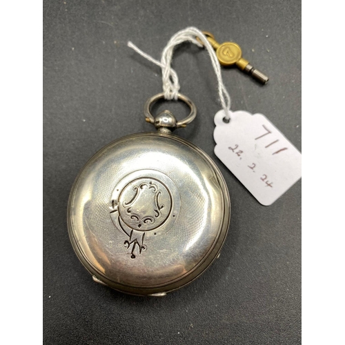 711 - A silver pocket watch with key and seconds dial