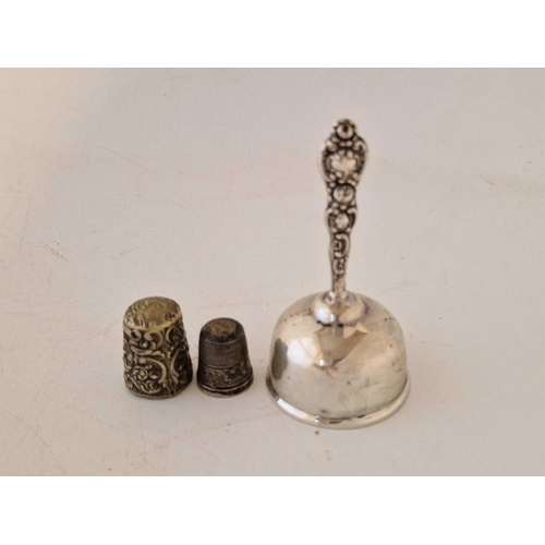 816 - A small table bell and two thimbles