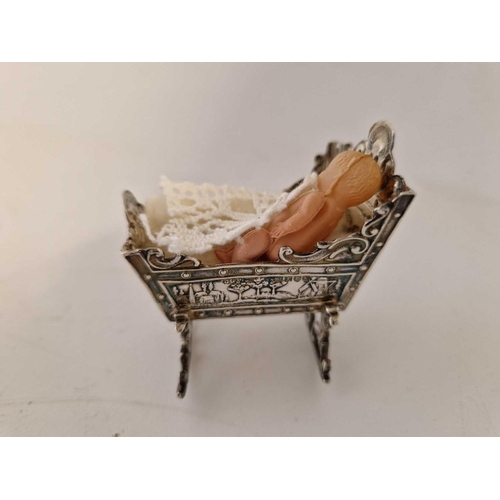 818 - A miniature Cot (Dutch) with chased decoration, 2.5