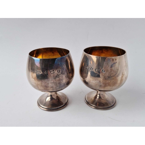 854 - A boxed pair of plain Brandy goblets on  spreading bases, 3 1/4