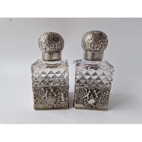 932 - A pair of square scent bottles with screw on covers and cut glass bodies, 5.5