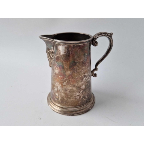 935 - An Irish cream jug with leaf caped handle and rim foot, 4 1/4