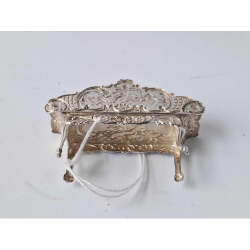 947 - Miniature sofa in French taste embossed with cherubs. 2.5 in wide, London 1959