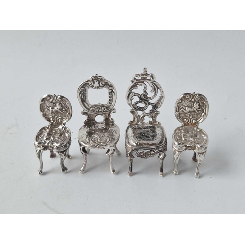 950 - Four miniature chairs with embossed decoration.