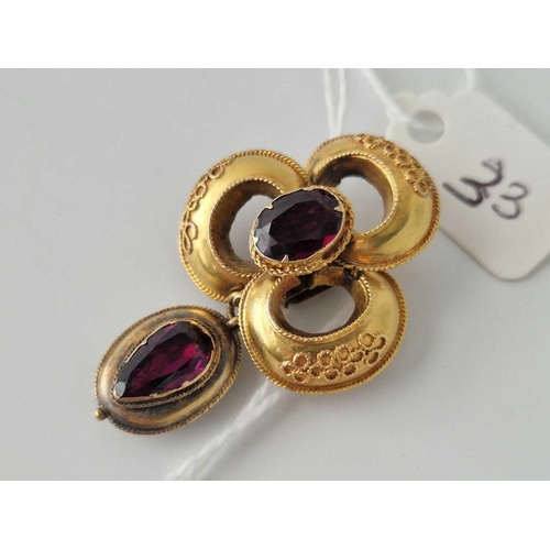 33 - A Victorian gold set garnet drop pendant the drop having a mourning locket