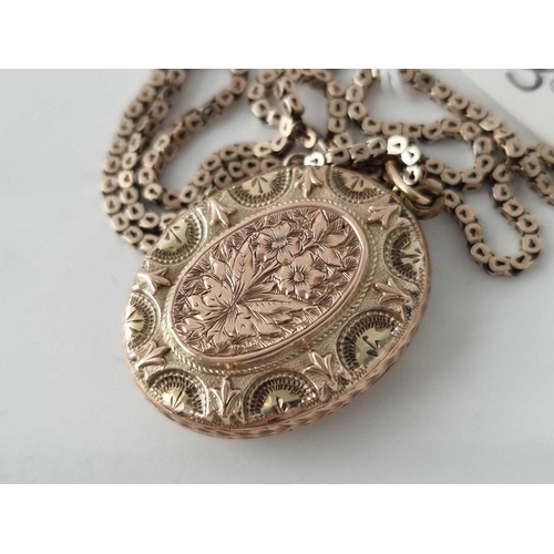 35 - A oval fancy locket in two colour gold on gilt square link box chain 15 inch