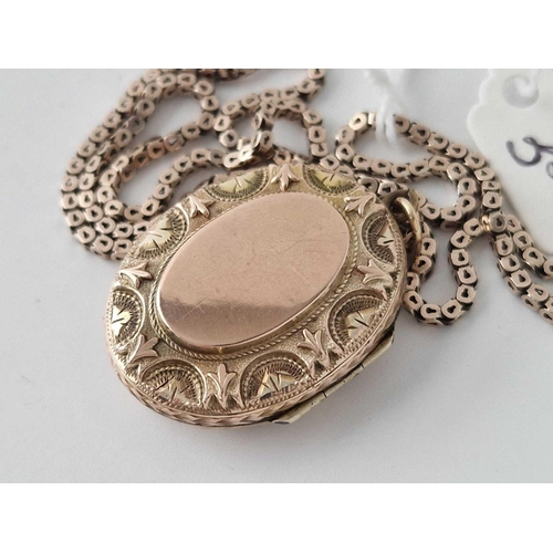 35 - A oval fancy locket in two colour gold on gilt square link box chain 15 inch