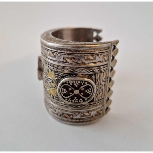 100 - A large ethnic silver bangle