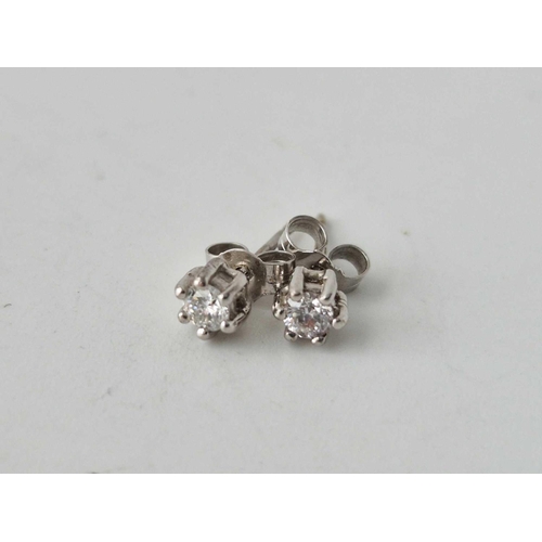 113 - A pair of diamond stud 9ct white gold earrings & a pair of cluster earrings