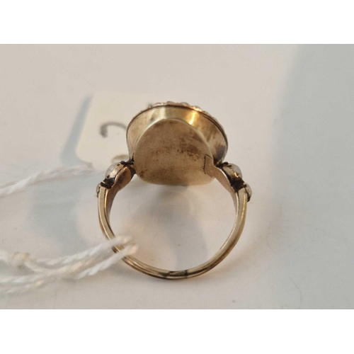 2 - A George III ring with bird and urn motif within a pearl border set in gold