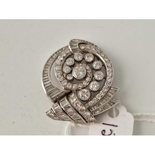 153 - A ATTRACTIVE ART DECO SWIRL DIAMOND BROOCH  WITH BAGUETTE AND BRILLIANT CUT DIAMONDS 12.7 GMS