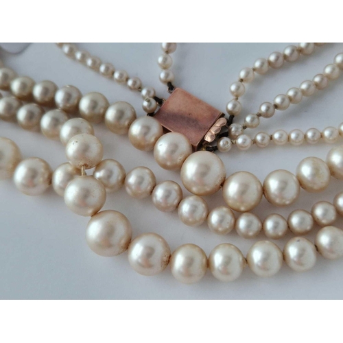 157 - A three string pearl necklace with 9ct clasp AF