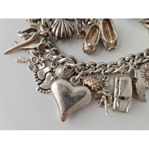 166 - A heavy silver charm bracelet 103 gms