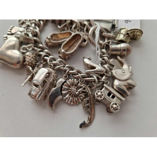 166 - A heavy silver charm bracelet 103 gms