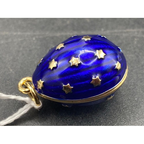 241 - A oversize egg shaped pendant with deep blue champleve enamel all set highlighted with six pointed s... 