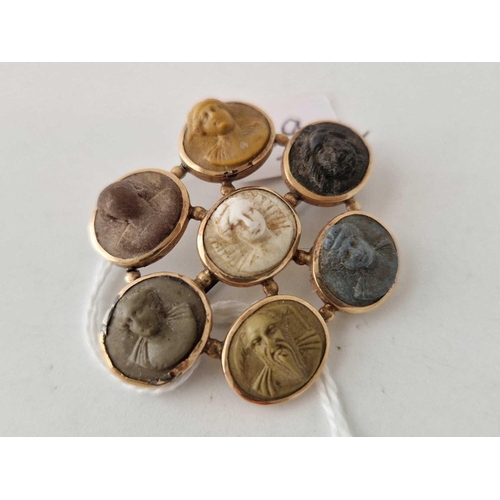 29 - A Victorian gold mounted brooch set with seven lava cameo of varying colours