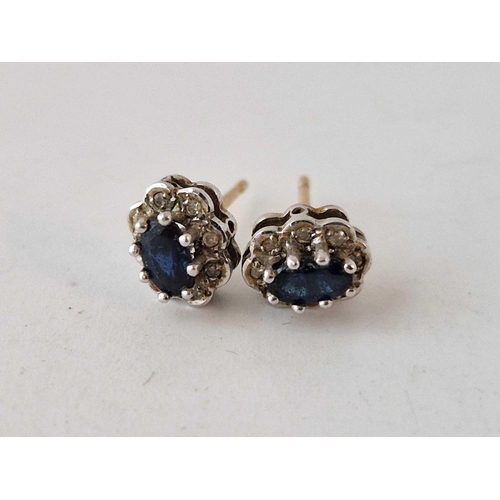 391 - A pair of sapphire and diamond circular earrings 1.2 gms