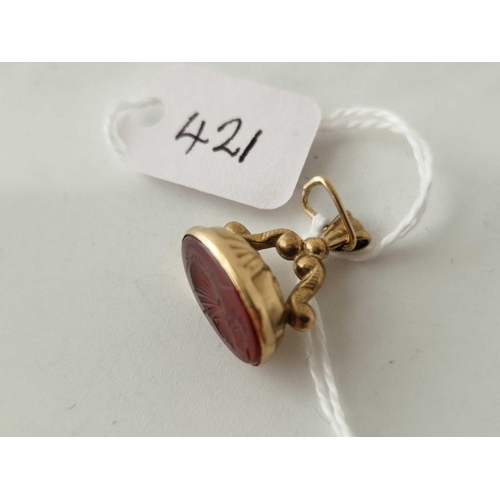 421 - A carnelian seal fob with a soldier 9ct 1.9 gms