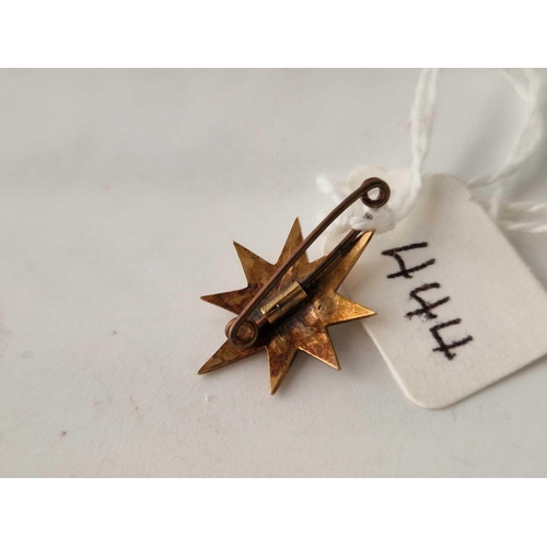 444 - A small pearl star brooch set in 15ct gold