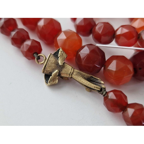 481 - A 19TH CENTURY CARNELIAN BEAD NECKLACE WITH UNUSUAL GOLD HAND CLASP 32 INCH