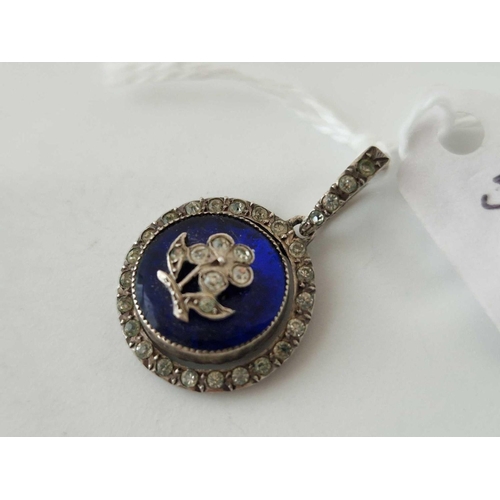 528 - A Edwardian silver circular pendant set paste and a blue enamel centre