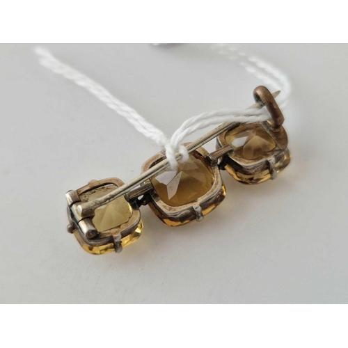 579 - A silver three stone citrine set bar brooch