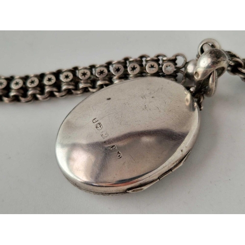 661 - A Victorian engraved silver locket and chain Birmingham 1895 40 gms