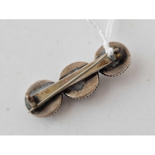 666 - A silver bar brooch set with three iridescent shells