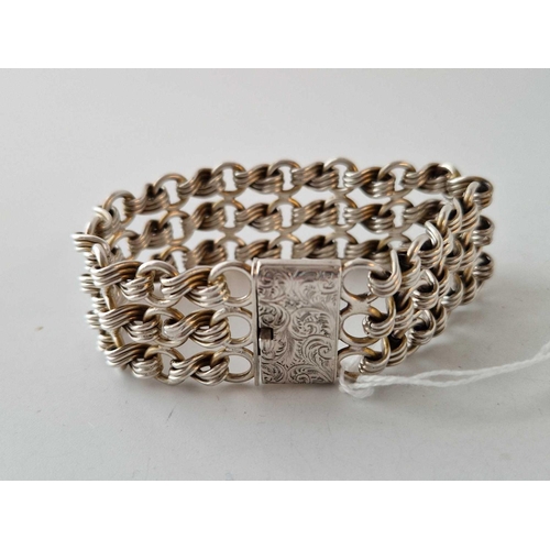 676 - A Victorian silver wide bracelet with three row stylized knot link design substantial quality