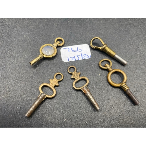 766 - A bag of five antique watch keys including a chalcedony set key