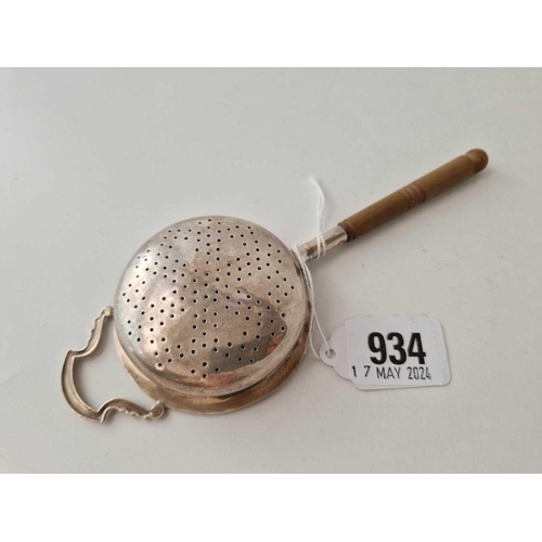 934 - A tea strainer with turned wood handle, Birmingham 1931