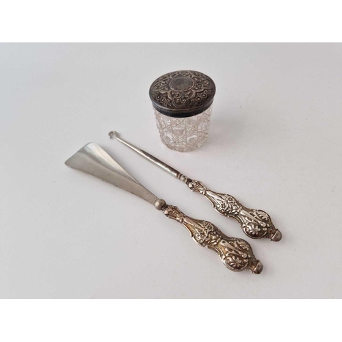 955 - Embossed top jar, Birmingham 1899, a button hook and a shoe horn