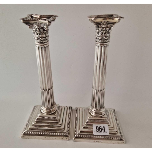 964 - A pair of candlesticks with step square bases, fluted stems and detatchable nozzles, 9.5