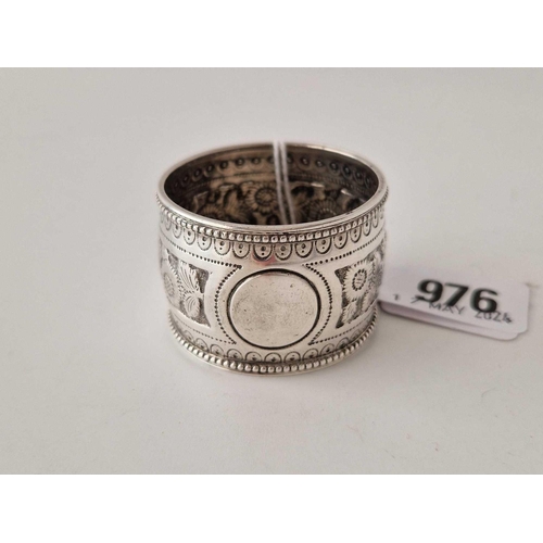 976 - A Victorian napkin ring with chased decoration, London 1887