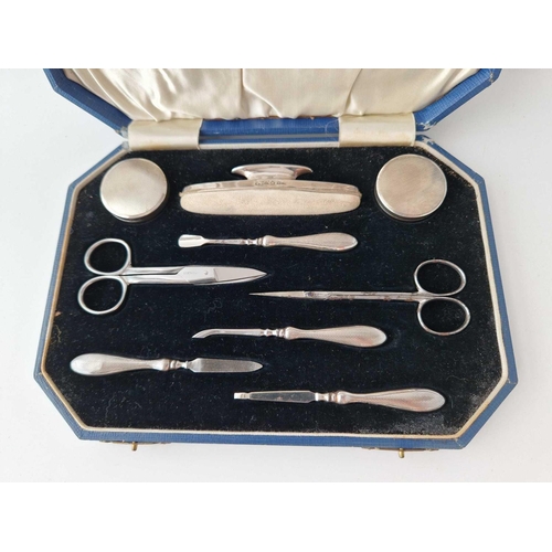 978 - A boxed manicure set with nail buffer, jars etc