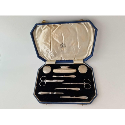 978 - A boxed manicure set with nail buffer, jars etc