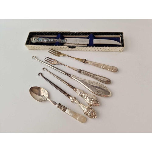 979 - A silver handled bread knife, a button hook etc