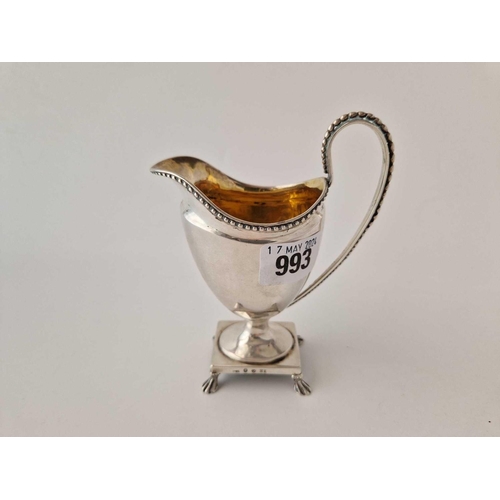 993 - An antique continental cream on square pedestal base with gilt interior, 5.5 inches high, 138 g