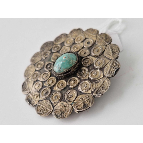 114 - Circular tribal brooch set with a centre turquoise, diameter 6cm