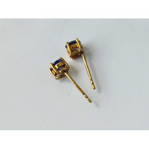 134 - A pair of tanzanite ear studs, 9ct