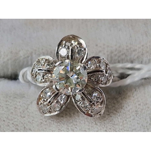 142 - A very attractive 18ct gold and platinum diamond flower head cluster ring with large central diamond... 