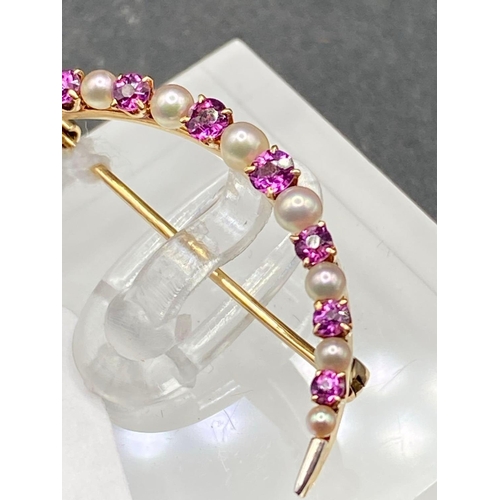 158 - A antique pearl and pink sapphire crescent brooch in high carat and platinum 2 g