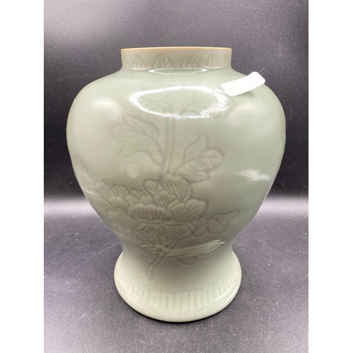 1821 - A green ground celadon vase, decorated with plants