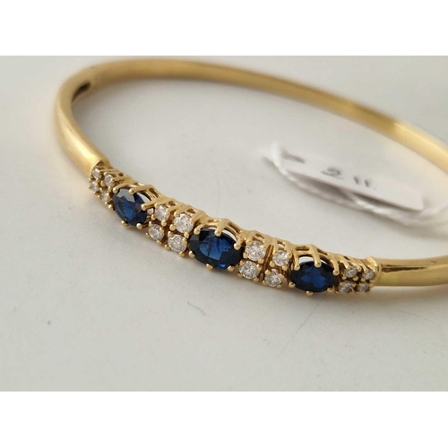 211 - A PRETTY DIAMOND AND SAPPHIRE BANGLE 18CT GOLD 15 g BOXED