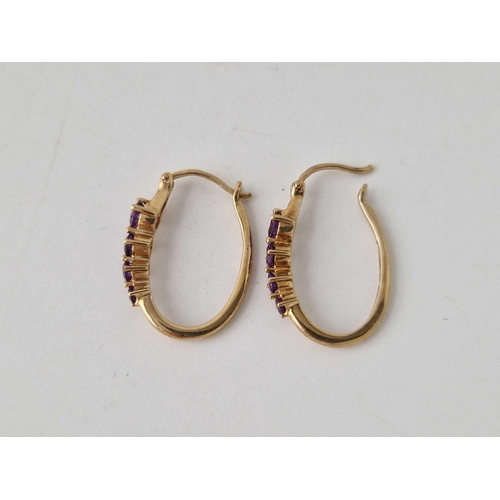 217 - A pair of amethyst 9ct hoop earrings 2.5g