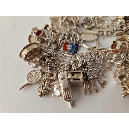 262 - A heavy vintage silver charm bracelet 102g