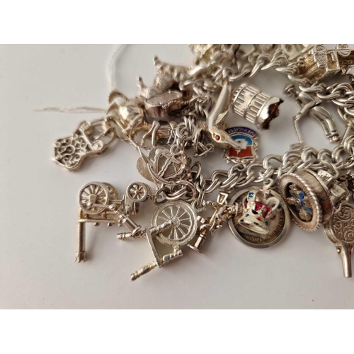 262 - A heavy vintage silver charm bracelet 102g