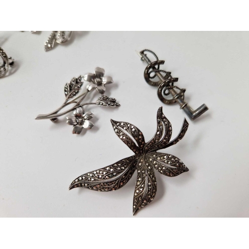 293 - Nine silver and marcasite brooches and pair of earrings, 83 g