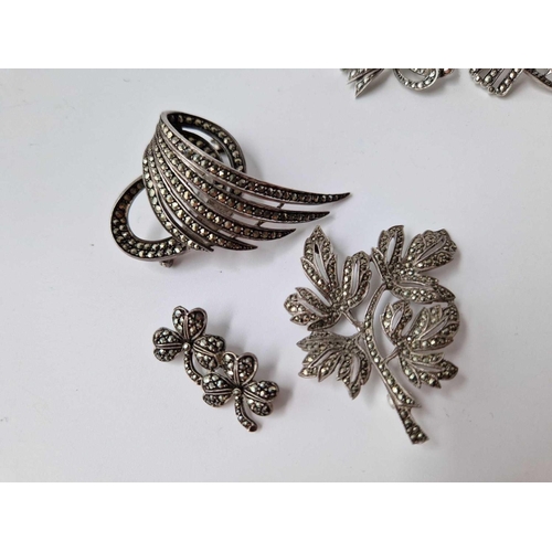 293 - Nine silver and marcasite brooches and pair of earrings, 83 g