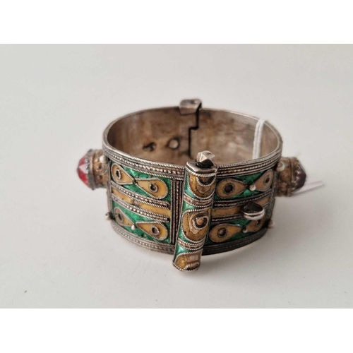 378 - A tribal silver and enamel cuff bangle hinged 64 g